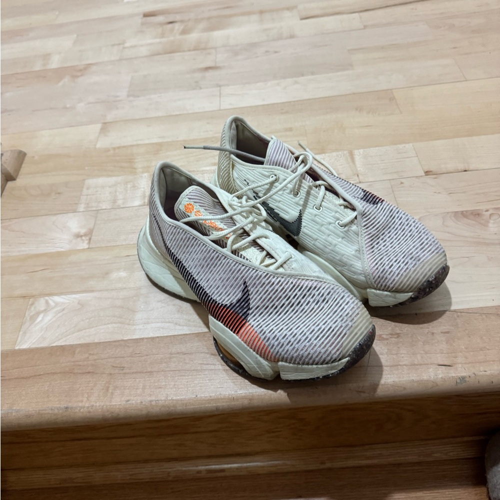 Nike Cream Knit Sneakers with Orange Accent and Black Swoosh